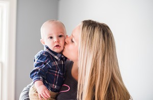 Megan kisses Jason, her lovable little boy.